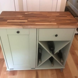 green kitchen island with wood top