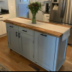 Blue kitchen island with wood top