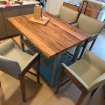 kitchen island with wood top surrounded by chairs